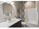 Modern bathroom with patterned shower curtain, round mirror, and decorative sink at 878 Tree Bark Ter, Colorado Springs, CO 80132