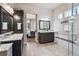 Spacious bathroom with dual vanities, glass enclosed shower, and view into the main bedroom at 878 Tree Bark Ter, Colorado Springs, CO 80132