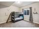 Cozy bedroom features bunk beds, a carpeted floor, and a window with natural light, perfect for  at 878 Tree Bark Ter, Colorado Springs, CO 80132