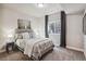 Well-lit bedroom showcasing a comfortable bed with decorative pillows, carpeted floors, and a window with natural light at 878 Tree Bark Ter, Colorado Springs, CO 80132