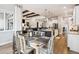 Open concept dining area boasts stylish table, kitchen island and view into the comfortable living area at 878 Tree Bark Ter, Colorado Springs, CO 80132