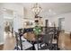 Dining room with rustic chandelier, wood floors, and a view into the rest of this beautiful home at 878 Tree Bark Ter, Colorado Springs, CO 80132