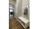 Bright entryway with hardwood floors, a built-in bench, and coat hooks at 878 Tree Bark Ter, Colorado Springs, CO 80132