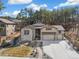 Charming two-story home featuring a stone facade, three-car garage, and professionally landscaped front yard at 878 Tree Bark Ter, Colorado Springs, CO 80132