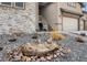 Beautiful landscaped front yard featuring a stone water feature and unique foliage at 878 Tree Bark Ter, Colorado Springs, CO 80132