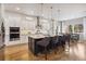 Modern kitchen features a large island with seating, stainless steel appliances, and hardwood floors at 878 Tree Bark Ter, Colorado Springs, CO 80132