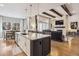 Modern kitchen with an island, stainless steel appliances, pendant lighting, and open floorplan to dining and living areas at 878 Tree Bark Ter, Colorado Springs, CO 80132