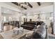 Open-concept living room featuring exposed beams, chandelier lighting, and access to the kitchen at 878 Tree Bark Ter, Colorado Springs, CO 80132