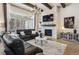Inviting living room with a brick fireplace, modern furnishings, and sliding doors to the patio at 878 Tree Bark Ter, Colorado Springs, CO 80132