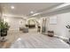 Open-concept living room with wet bar, ample seating, and a carpeted floor, perfect for entertaining guests at 878 Tree Bark Ter, Colorado Springs, CO 80132