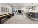 Expansive living room with shuffleboard, wet bar, and comfortable seating, perfect for entertaining guests at 878 Tree Bark Ter, Colorado Springs, CO 80132