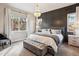 Beautiful main bedroom featuring board and batten accent wall, sitting area, and large windows at 878 Tree Bark Ter, Colorado Springs, CO 80132