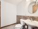 Neutral bathroom featuring a toilet, pedestal sink, and ceramic tile flooring at 5843 S Danube St, Aurora, CO 80015