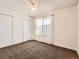 Cozy bedroom with carpeted floors, large window, and a closet at 5843 S Danube St, Aurora, CO 80015