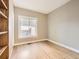 Simple bedroom with hardwood floors, base trim, and a window at 5843 S Danube St, Aurora, CO 80015