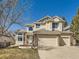 Charming two-story home featuring a three-car garage and classic brick and siding exterior at 5843 S Danube St, Aurora, CO 80015