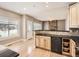 Well-designed kitchen featuring a breakfast bar with wooden cabinetry and granite countertops at 5843 S Danube St, Aurora, CO 80015