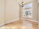 Bright living room with hardwood floors, transom windows, and elegant light fixtures at 5843 S Danube St, Aurora, CO 80015