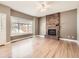 Inviting living room with a cozy brick fireplace, ceiling fan and natural light at 5843 S Danube St, Aurora, CO 80015