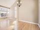 Sunlit living room with large windows, hardwood floors, and contemporary lighting at 5843 S Danube St, Aurora, CO 80015