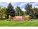 Tuscany community entrance sign surrounded by colorful flowers and mature trees at 5843 S Danube St, Aurora, CO 80015