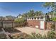Backyard with brick building, white door, fenced yard, concrete patio, and landscaped garden beds at 764 S Sherman St, Denver, CO 80209