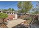 Backyard featuring a brick building, wooden fence, concrete patio, and landscaping with plants at 764 S Sherman St, Denver, CO 80209