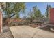 Backyard with concrete patio, wooden fence, landscaped garden, and mature trees at 764 S Sherman St, Denver, CO 80209