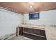 Unfinished basement with exposed beams, workbench, and a boarded-up window at 764 S Sherman St, Denver, CO 80209