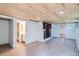 Finished basement with wood plank ceiling, recessed lighting, and wood-look flooring; also features bathroom and built-in shelving at 764 S Sherman St, Denver, CO 80209