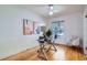 Light filled bedroom featuring a glass desk, ceiling fan and wood floors at 764 S Sherman St, Denver, CO 80209