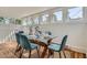 Bright dining area featuring a glass table and six teal upholstered chairs at 764 S Sherman St, Denver, CO 80209