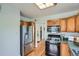 Bright kitchen featuring stainless steel appliances and oak cabinets at 764 S Sherman St, Denver, CO 80209