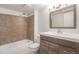 Bathroom with a tub, toilet and brown vanity at 1150 Inca St # 59, Denver, CO 80204