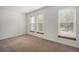 Bright bedroom with neutral carpeting and three large windows at 1150 Inca St # 59, Denver, CO 80204