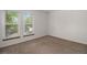Bright bedroom with neutral carpeting and two windows at 1150 Inca St # 59, Denver, CO 80204