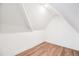 View of the attic featuring a sloped ceiling and light wood floors at 1076 Mariposa St, Denver, CO 80204
