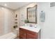 Bathroom with a vanity with a mirror and a walk-in shower with tiled walls at 1076 Mariposa St, Denver, CO 80204