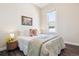 Cozy bedroom features a queen size bed, side table, and natural light from the window at 1076 Mariposa St, Denver, CO 80204