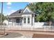 Charming two-story home with blue and white trim and a white picket fence at 1076 Mariposa St, Denver, CO 80204
