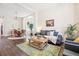 Comfortable living room open to dining area, featuring a large couch and hardwood floors at 1076 Mariposa St, Denver, CO 80204