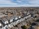 Scenic aerial view of modern townhomes in a vibrant community with city skyline backdrop at 1206 S Reed St, Lakewood, CO 80232