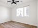 Bedroom featuring a large window, wood floors, recessed lights and baseboard trim at 1206 S Reed St, Lakewood, CO 80232