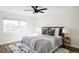 Bright bedroom featuring a large window, plush bedding, and stylish side tables at 1206 S Reed St, Lakewood, CO 80232