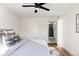 Bedroom featuring a ceiling fan, recessed lighting, wood floors and an open doorway to the bathroom at 1206 S Reed St, Lakewood, CO 80232
