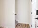 Inviting entryway featuring wood floors, neutral walls, leading to carpeted stairs at 1206 S Reed St, Lakewood, CO 80232