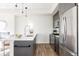 Modern kitchen with stainless steel appliances, pendant lights, and an open layout at 1206 S Reed St, Lakewood, CO 80232
