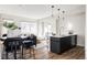 Inviting living area featuring a modern kitchen, dining space, and cozy seating area at 1206 S Reed St, Lakewood, CO 80232