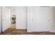Living area with hardwood floors, white trim and a view into a dining area at 1206 S Reed St, Lakewood, CO 80232