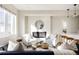 Bright living room features a modern fireplace, stylish seating, and sunlit windows at 1206 S Reed St, Lakewood, CO 80232